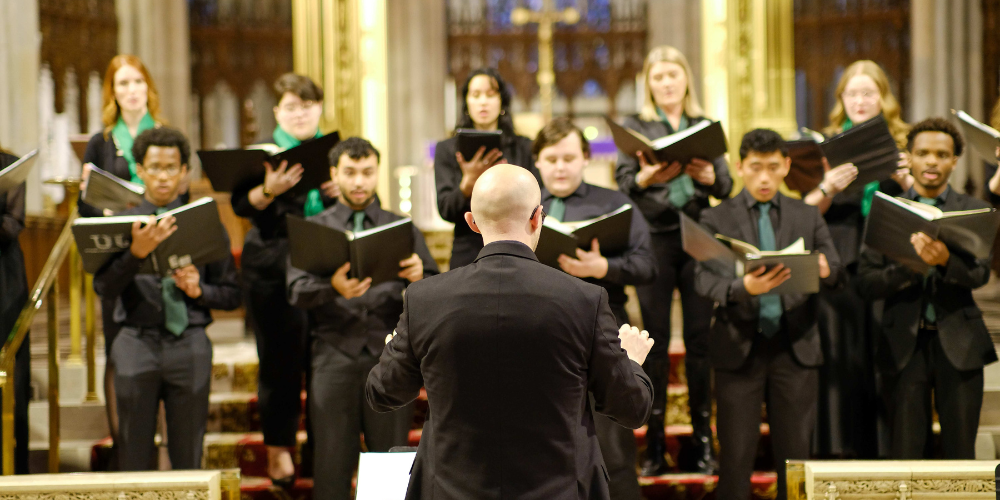 Conductor in front of a choir at a cathedral 